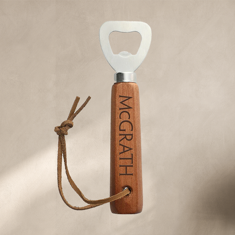 Bottle opener with wooden handle engraved with McGrath and leather wrist strap