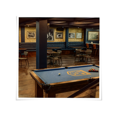 Private event space at House of McGrath featuring a billiards table and lounge seating